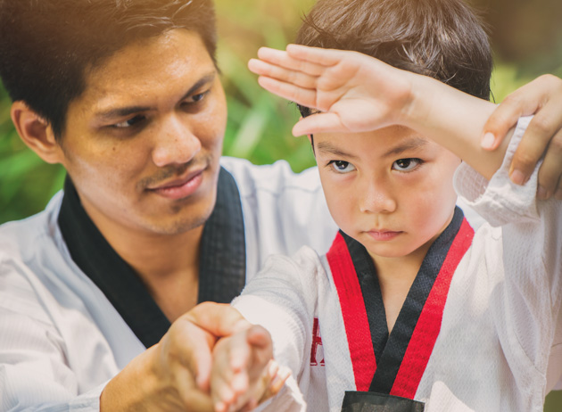 teaching children martial arts, Taekwondo master with student