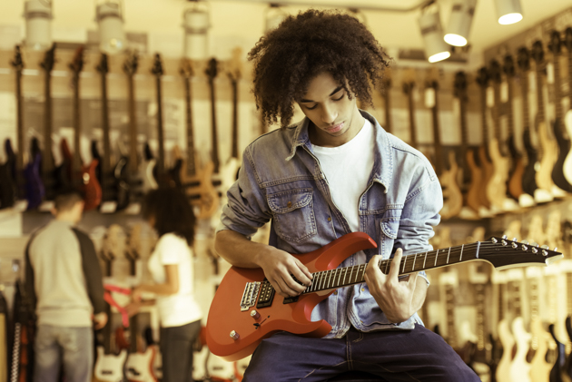 merchandise at your music school, Man playing electric guitar